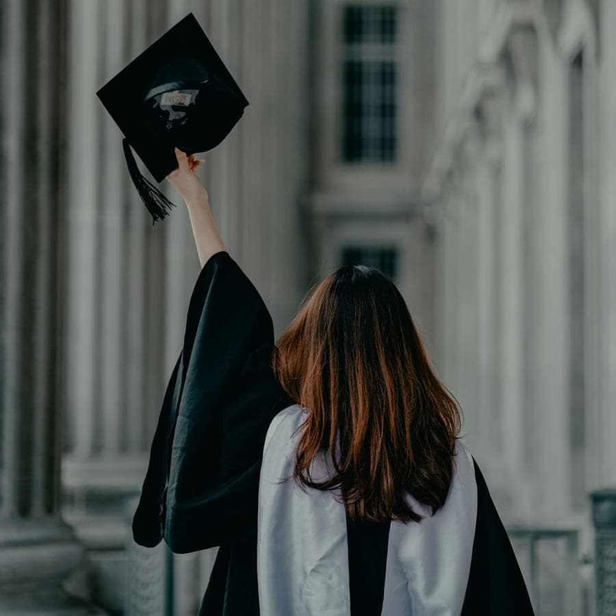 A graduate raising her cap